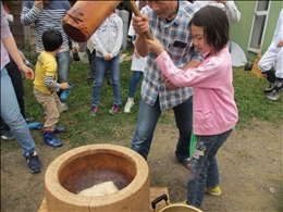 杵を振り上げ、餅つきに挑む